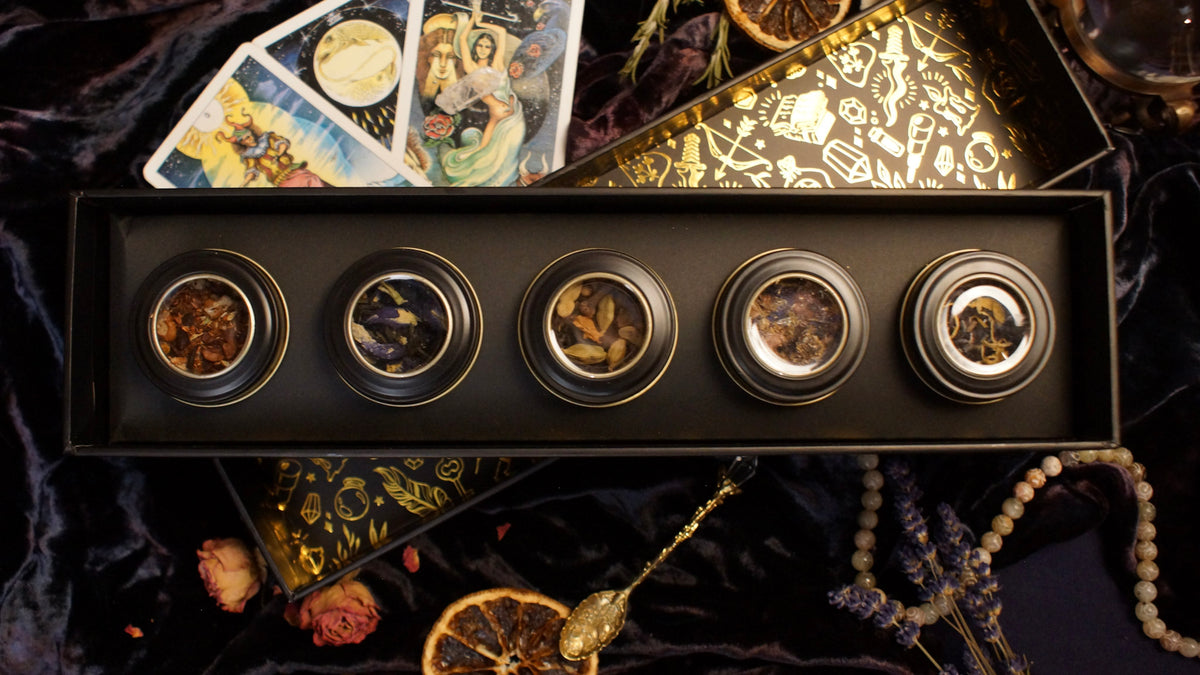 5 tins of tea in a decorative black box