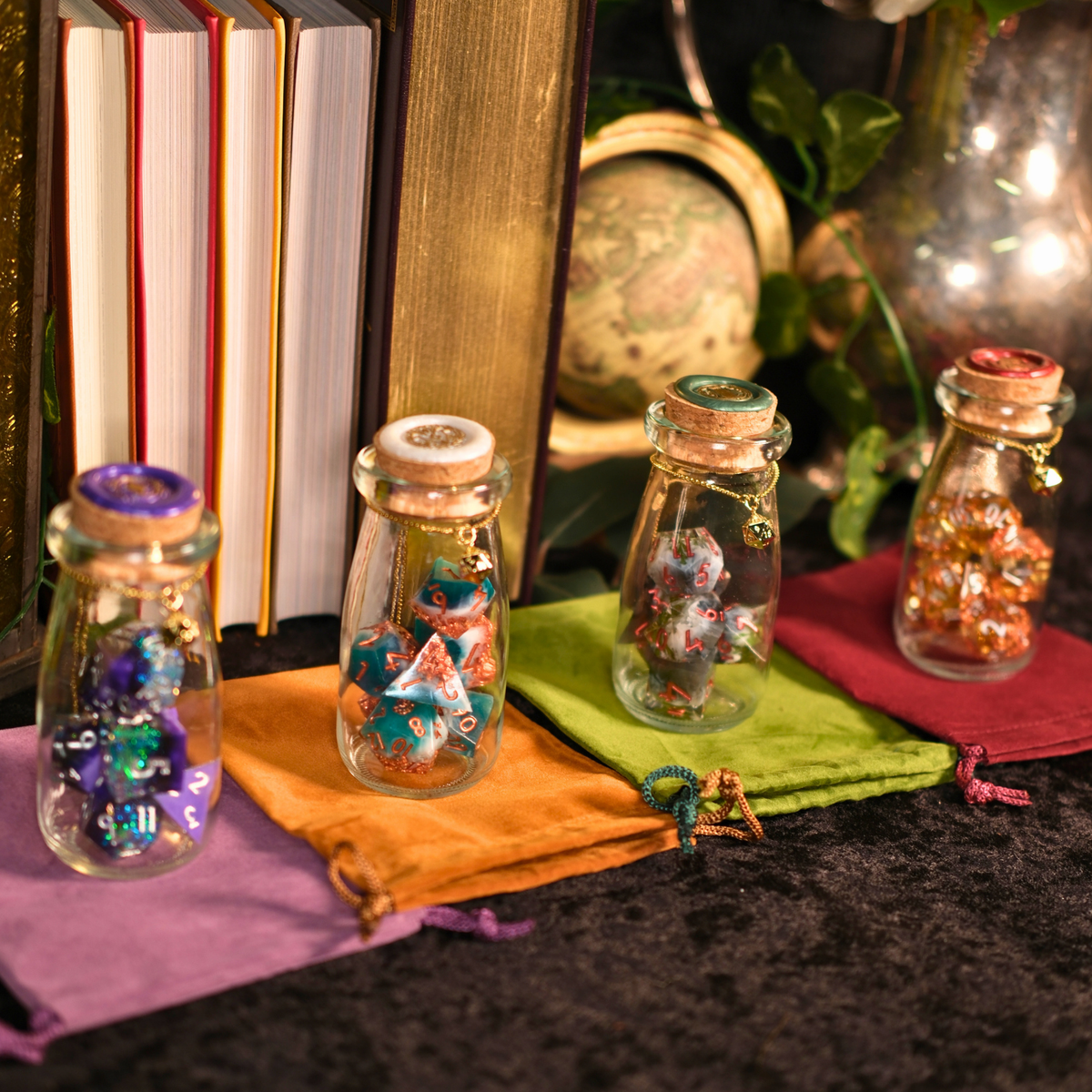 Small glass jars with colorful contents on a dark surface with books and decorative items in the background.
