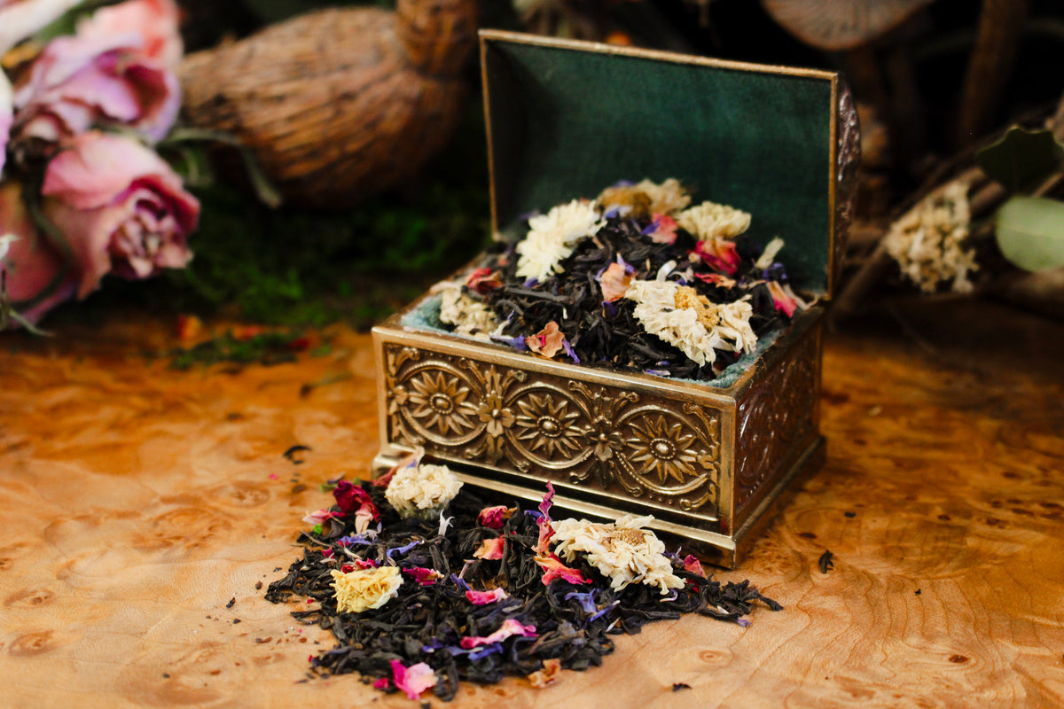 Decorative box with dried flowers and leaves on a wooden surface