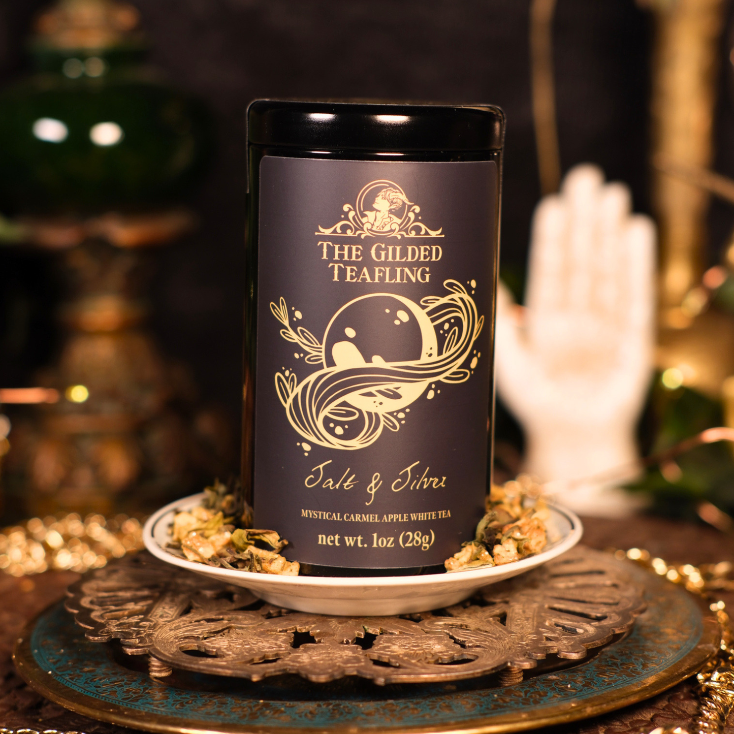 Tea canister labeled "Salt and Silver" on a decorative plate with a mystical moon design.