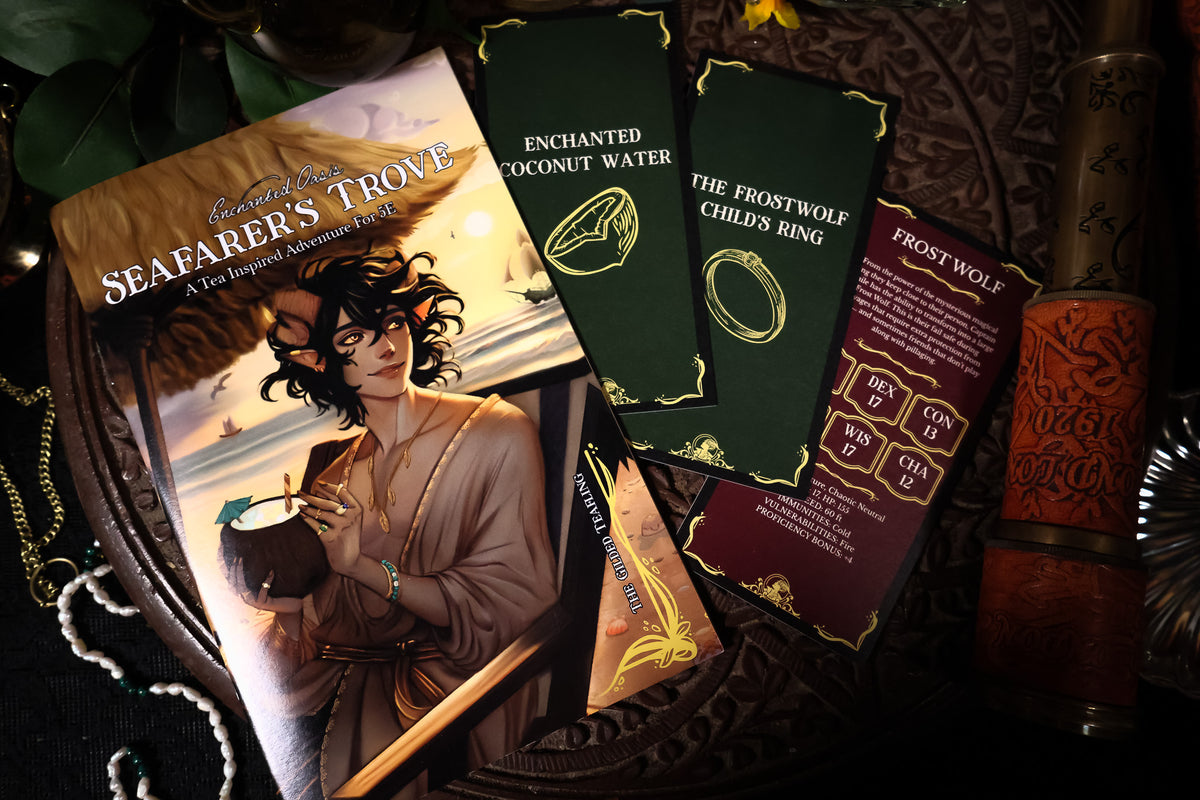 A styled flat-lay of a tabletop gaming book titled 'Seafarer's Trove' with illustrated cards and game pieces arranged on a dark carved wooden tray alongside a brass telescope and decorative beads.